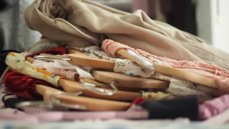 messy pile of clothes on hangers