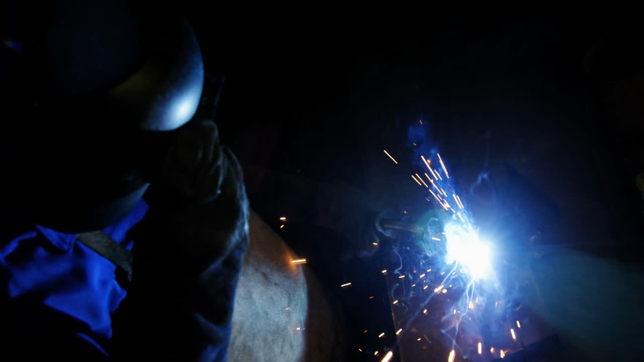 Male and female welders working together
