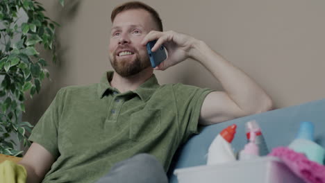 man talking on phone while cleaning
