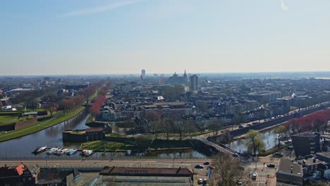 jib down of the beautiful city of den bosch with a bridge running over the dieze river surrounding the city