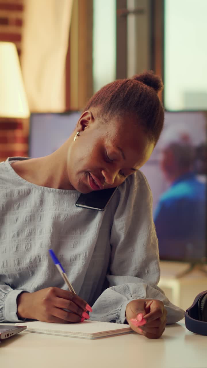 Vertical Freelancer writing notes from phone call