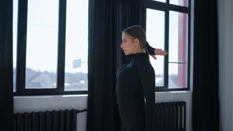 woman stretching her arms in a gym