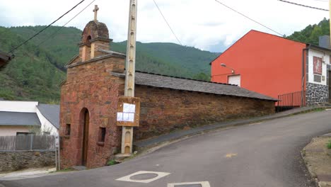 close-up of san lorenzo de somoza chapel entrance, showing detailed stonework and rural surroundings