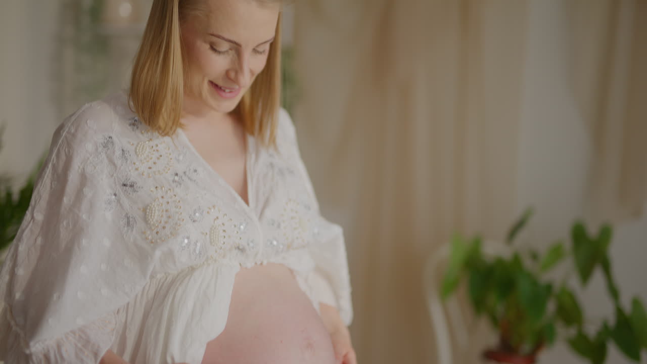 Pregnant Woman Embracing Belly Closeup