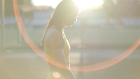 female athlete running on outdoor track in sportswear