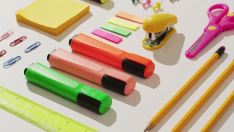 video of markers, pencils, scissors and diverse office accessories lying on white surface