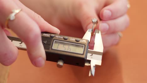 Golden-wedding-ring-getting-measured-by-female-hands