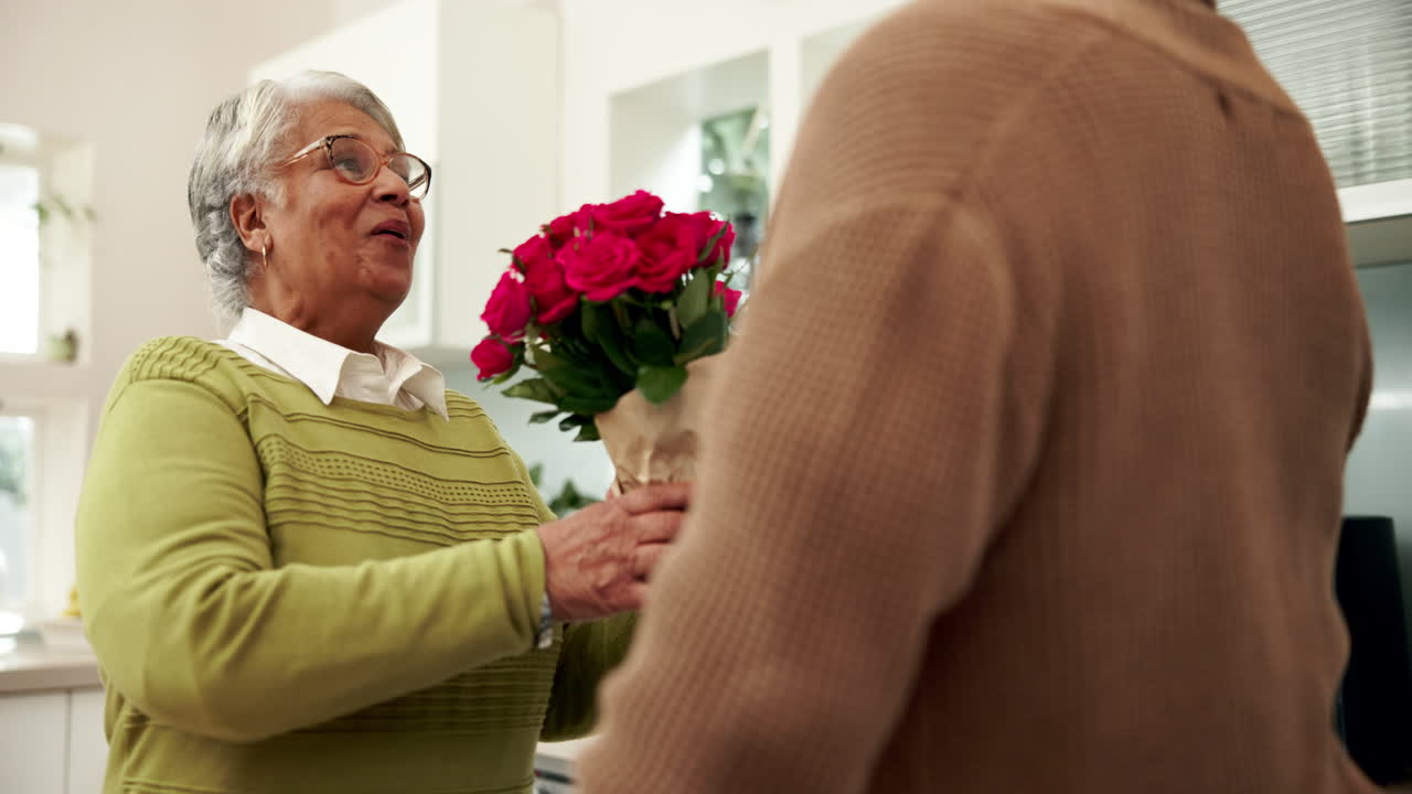 Elderly couple sharing a bouquet of roses