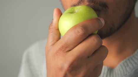 a person eating a green apple