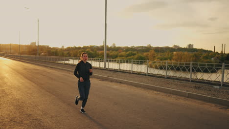 yougn female runner is training outdoors in summer morning or evening jog for good physical condition