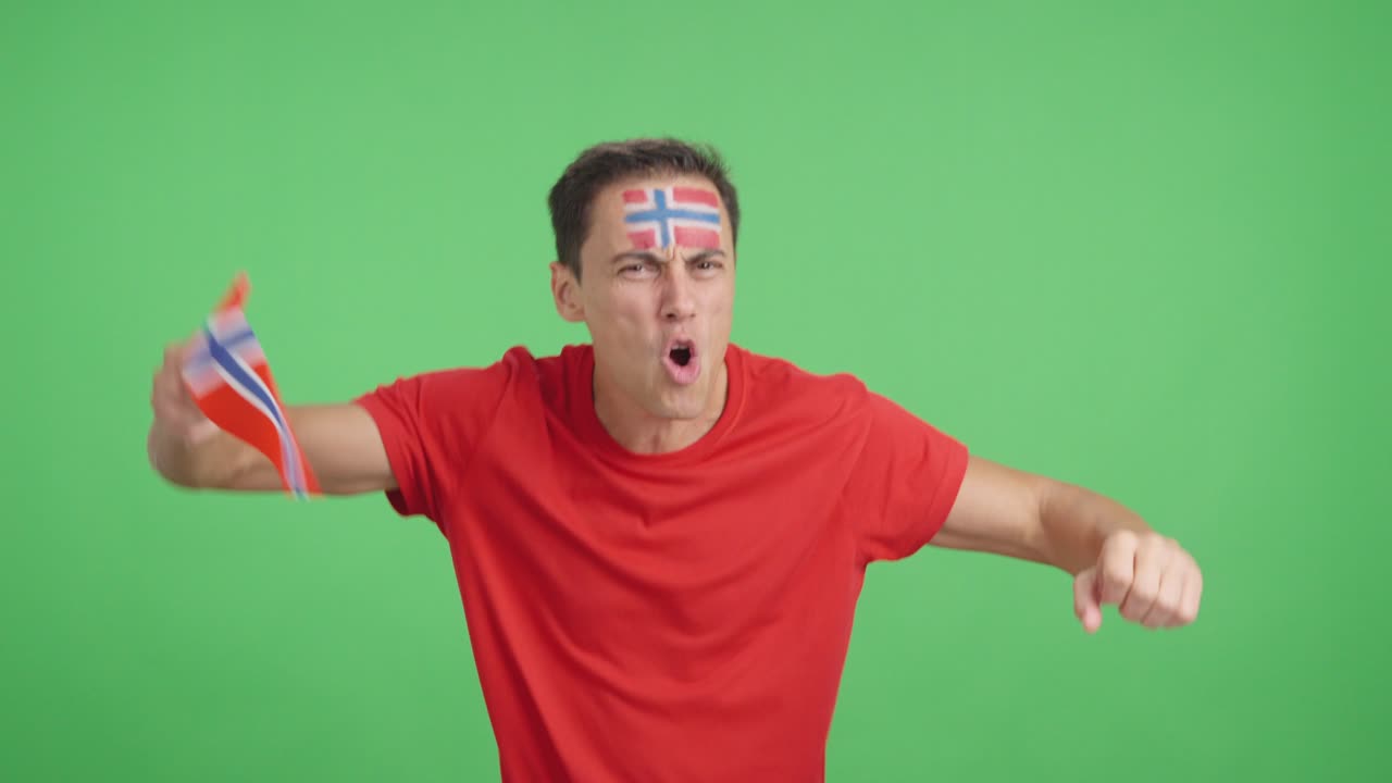 Man cheering for Norway screaming and waving a national flag