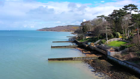 aerial flying over sea front houses isle of wight sunny day uk 4k