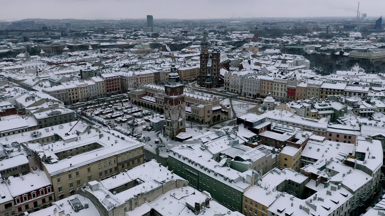 Snow-covered Old Town (Krakow city center - Main Square, Sukiennice - Cloth Hall and Town Hall) at magic morning with sunlight, Krakow, Poland