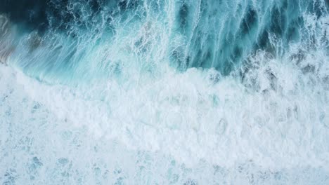 Beautiful-drone-shot-of-a-surfer-passing-under-a-wave-in-a-raging-sea