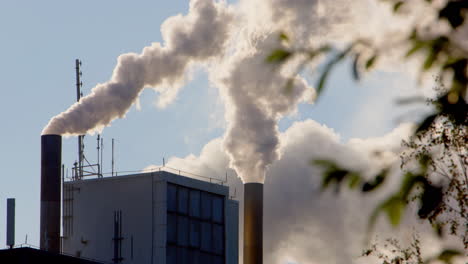 factory smokestacks emitting pollution into the atmosphere
