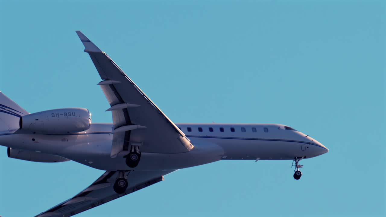 Nice, France - March 17, 2025: Close up of an airplane flying on the blue sky in daylight