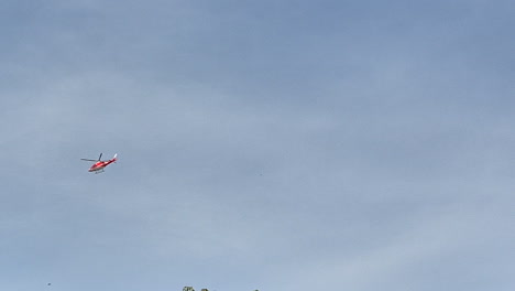 slow motion of a medical helicopter flying in the sky