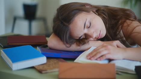 woman sleeping on books bored