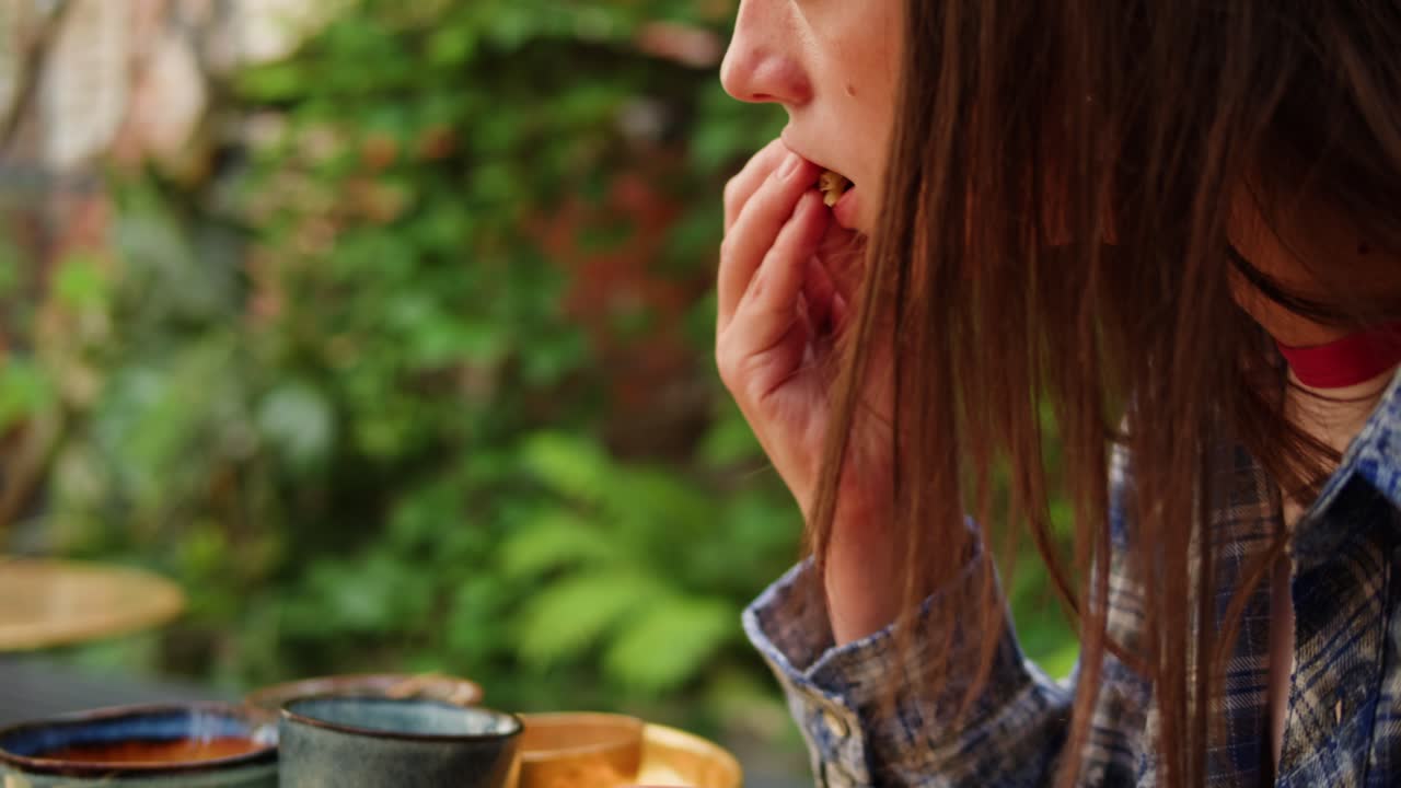 Woman Eating Roti in a Garden Setting