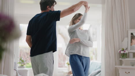 happy young couple dancing at home celebrating having fun weekend morning together enjoying funny dance in bedroom successful relationship celebration 4k footage