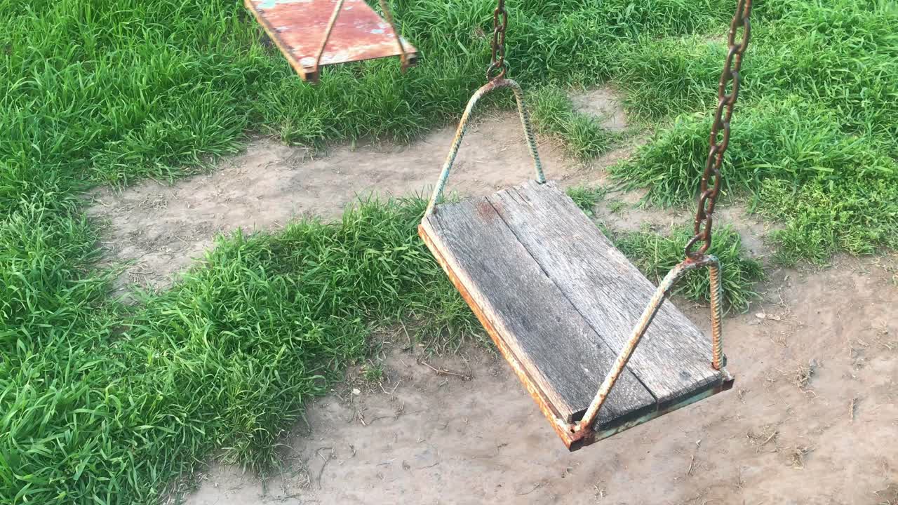 Abandoned Park Swing Gently Swaying