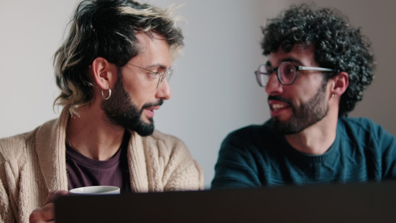 Gay Couple Watching Something Funny on Laptop