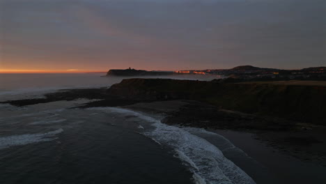 establishing aerial drone shot of cleveland way with scarborough in background