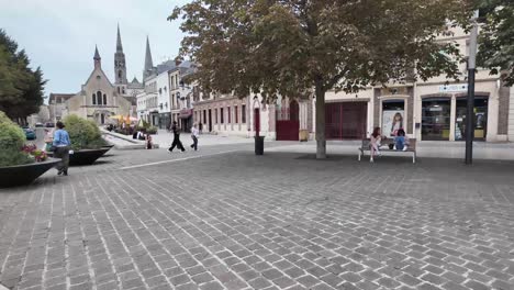 crossing the road on foot and walking towards cathedral towers in chartres, france.