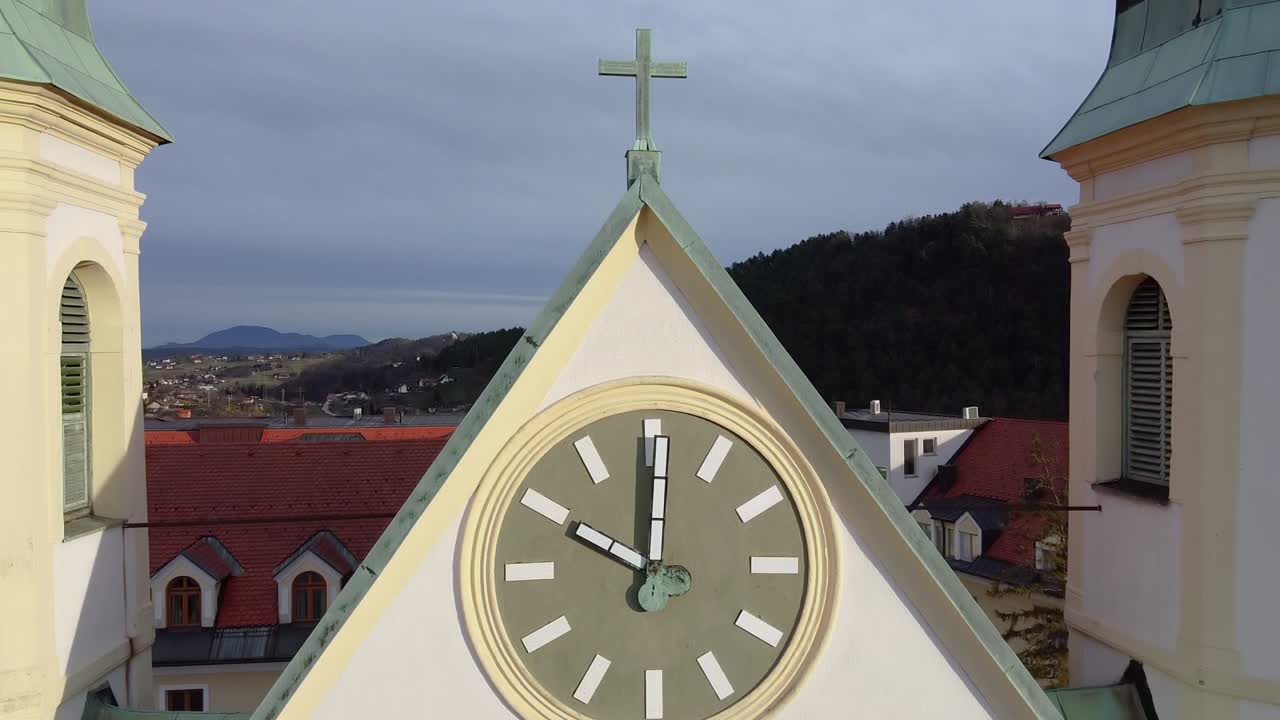 Aerial jib up of Saint Joseph church clock and revealing surrounding areas