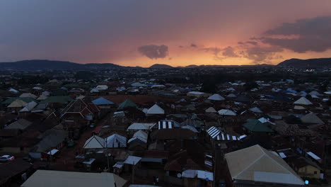 The-Jahi-District-of-Abuja,-Nigeria-at-sunset-is-growing-in-population---descending-aerial-view