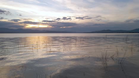 Calm---Glossy-Water-of-Utah-Lake-during-Vibrant-Sunset,-Aerial-Drone