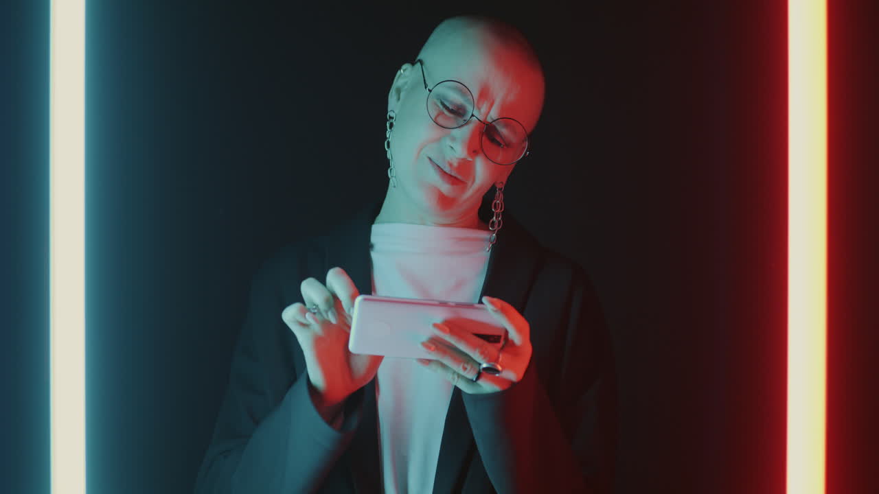 Woman using a phone in neon light