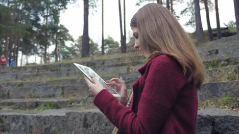 woman using tablet in a park