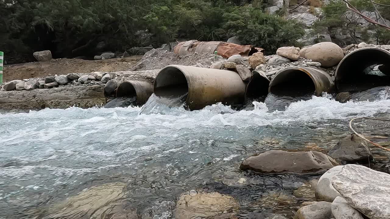 drainage pipes with a lot of water flowing demonstrating civil engineering in an environment somewhat destroyed by a hurricane