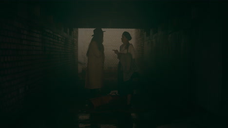 two women discussion in tunnel