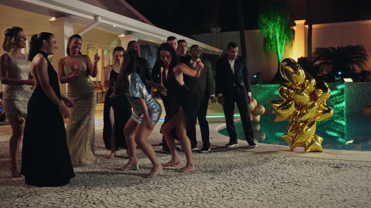 People Dancing and Socializing at an Elegant Nighttime Pool Party