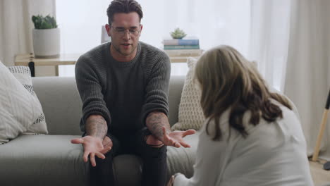 young man talking to a psychologist while sitting