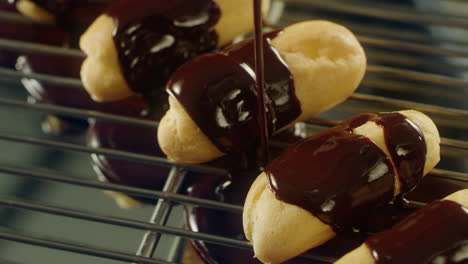 choux pastry covering with chocolate icing at professional restaurant.