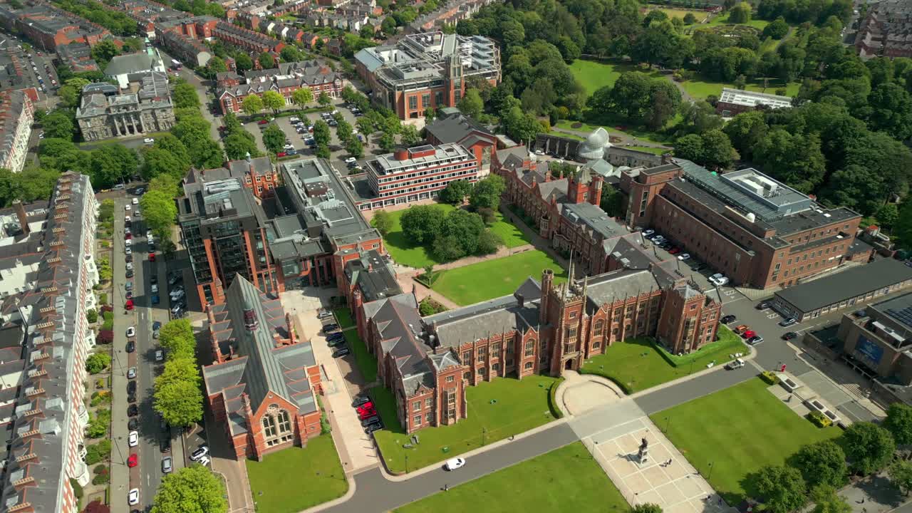 Side-on aerial video of Queen's University Belfast, in Northern Ireland, UK on a bright and sunny day. Produced at 4K resolution, 60FPS and with Rec709 color.