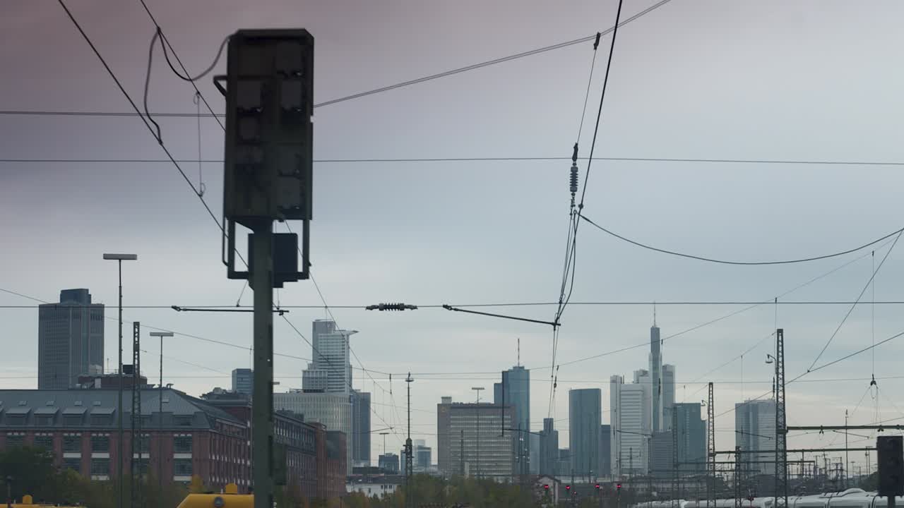 Urban Skyline with Overhead Power Lines and Railway Infrastructure