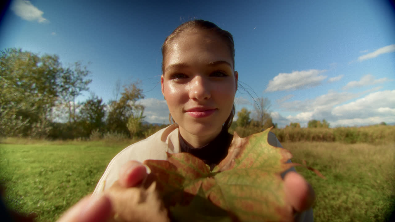 Young Woman Holding Autumn Leaves
