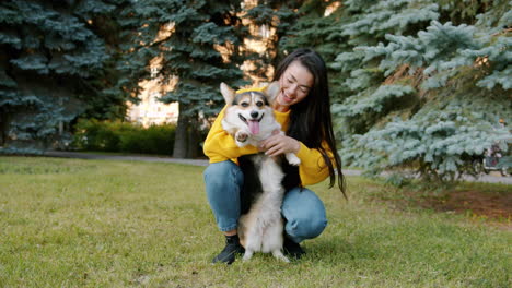 woman and her corgi in a park