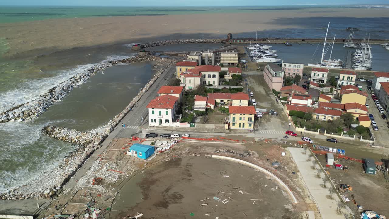 Rotating aerial capturing daytime atmosphere of coastal shores of Marina di Pisa, seaside resort of Tuscany, in central Italy