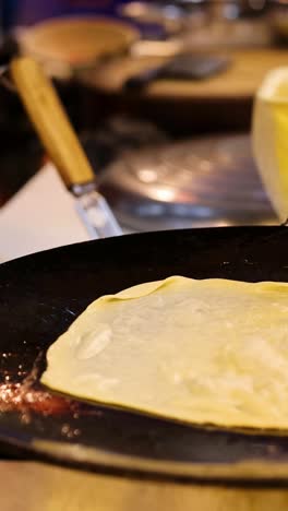 vendor prepares roti with egg and banana