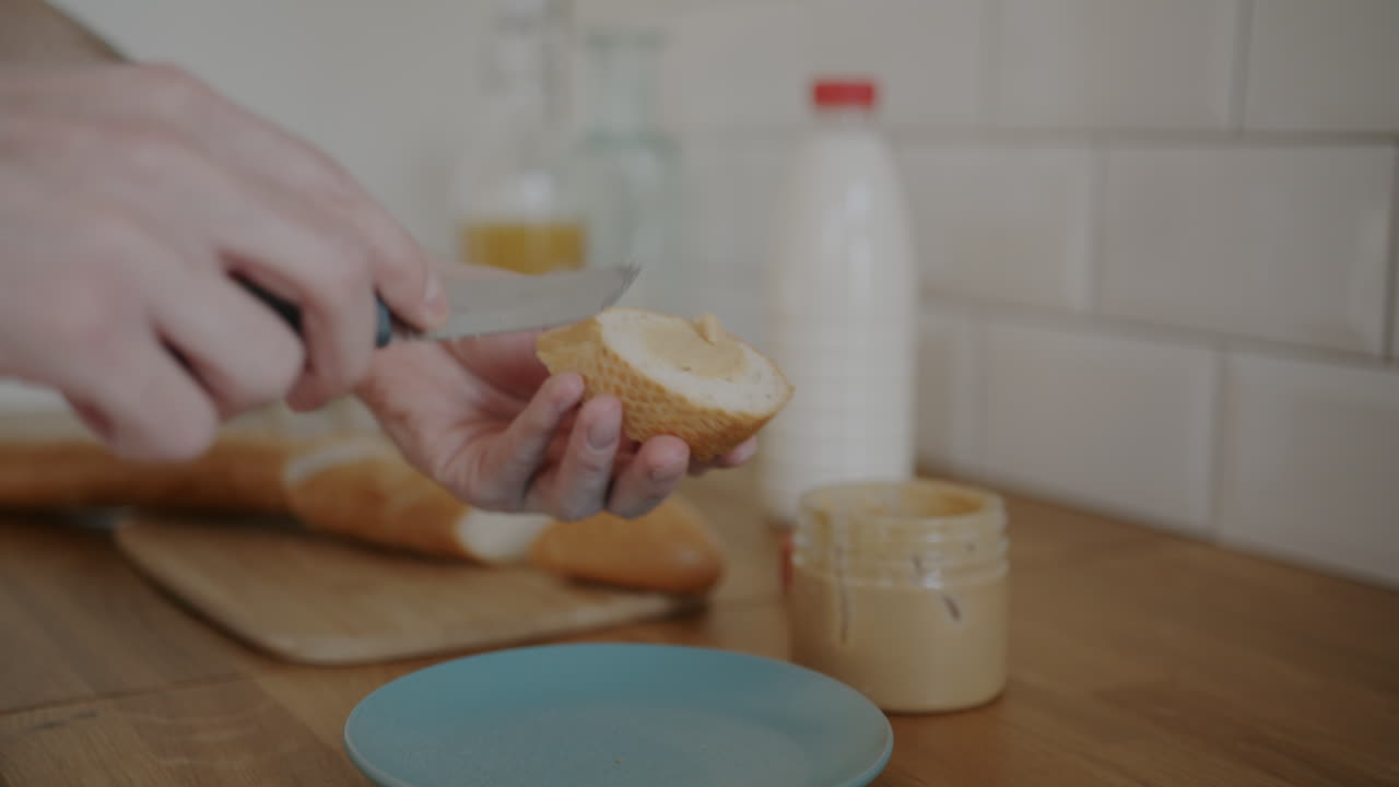 Person preparing a peanut butter sandwich