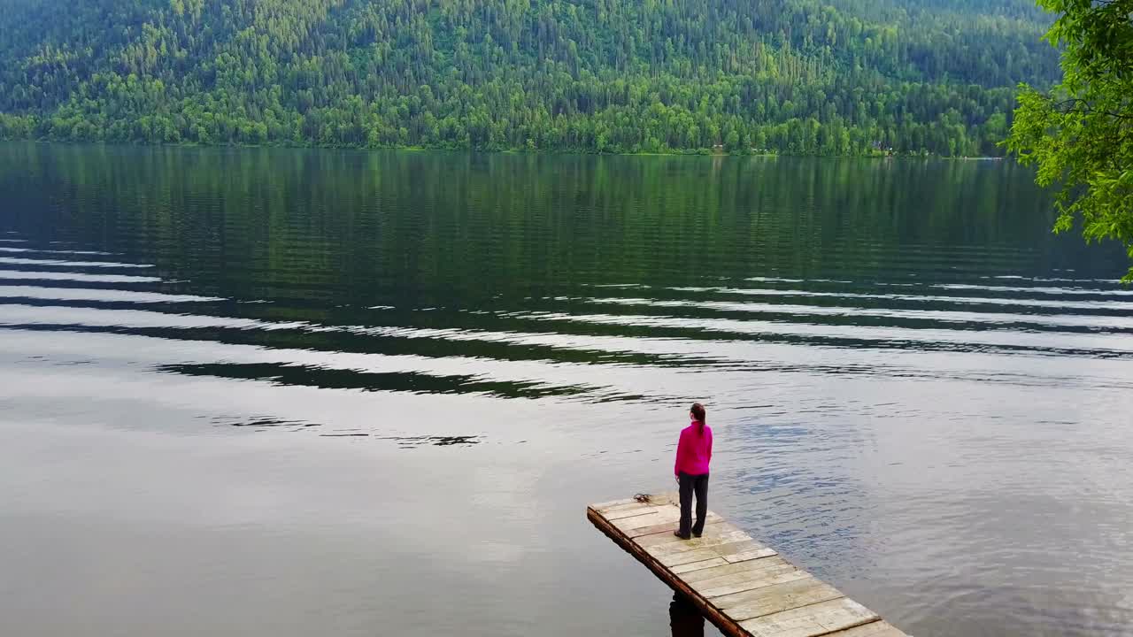 Peaceful Lakeside Scene with Person on Dock