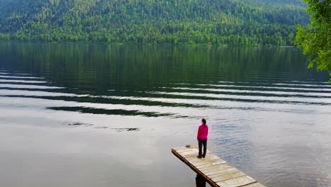 peaceful lakeside scene with person on dock
