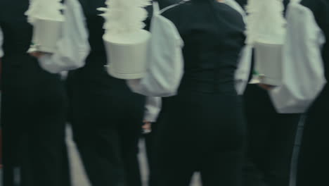 cinematic high school marching band members walking by in slow motion