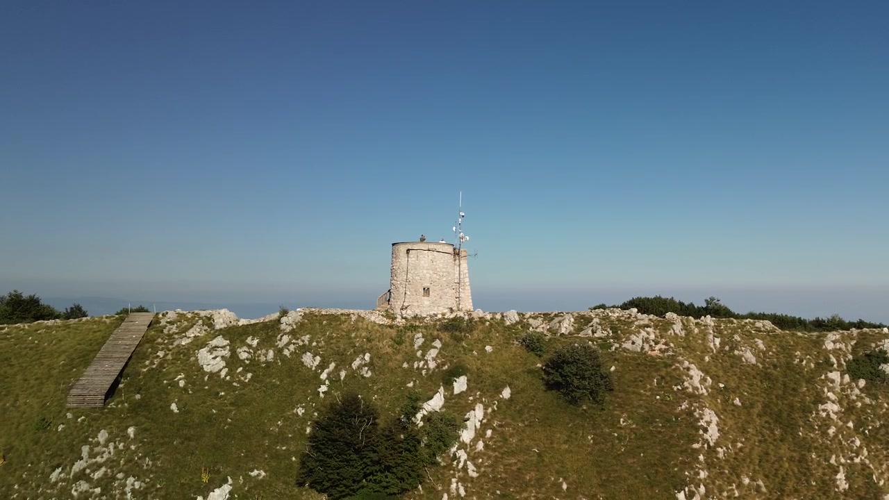 Vista aerea laterale da drone di una cresta montuosa aspra e della Torre di Vojak, Croazia