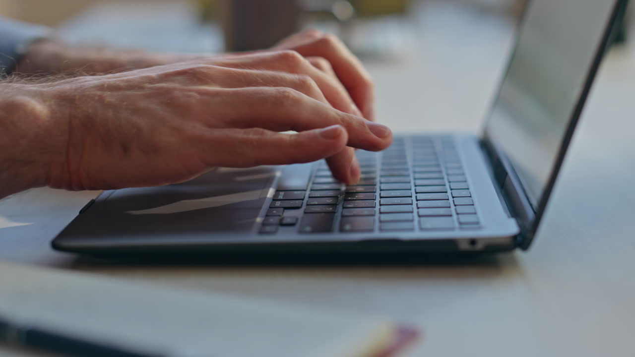 Closeup man hands typing pc keyboard in office. Busy manager surfing internet